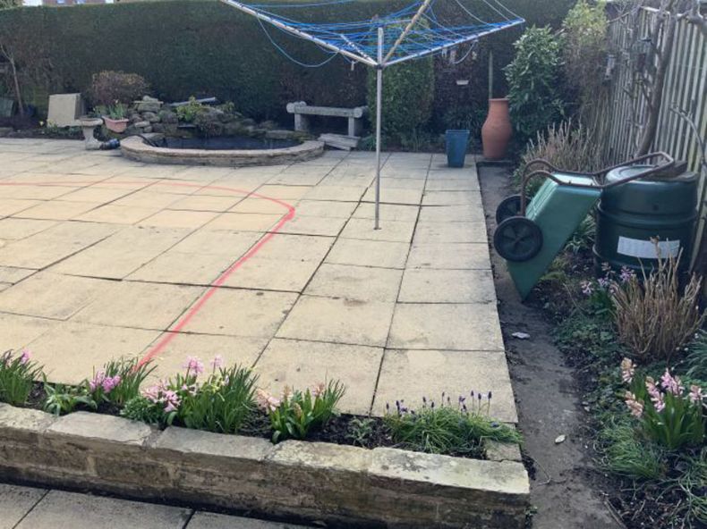 Before image of flagged patio area