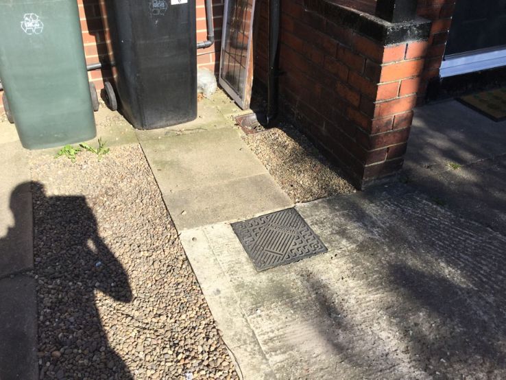 Before image of a concrete paving slab driveway area